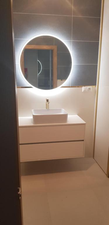 a bathroom with a sink and a mirror at Meridiem byt in Topoľčany