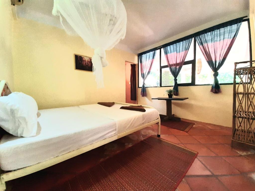 Postel nebo postele na pokoji v ubytování Jungle House Kep
