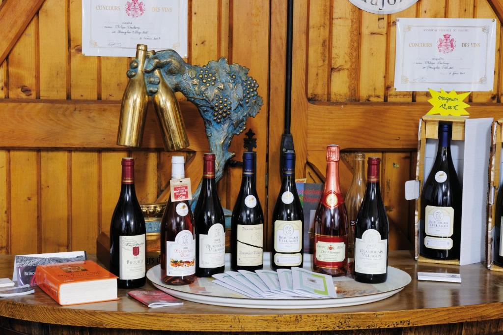 a bunch of bottles of wine on a table at Domaine viticole Philippe Deschamps in Beaujeu