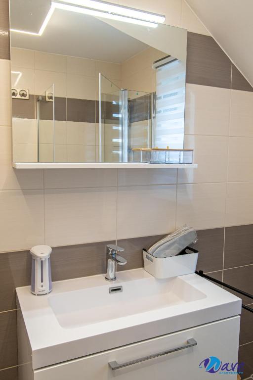 a bathroom with a sink and a mirror at MODERN apartments WAVE near the AIRPORT in Velika Gorica