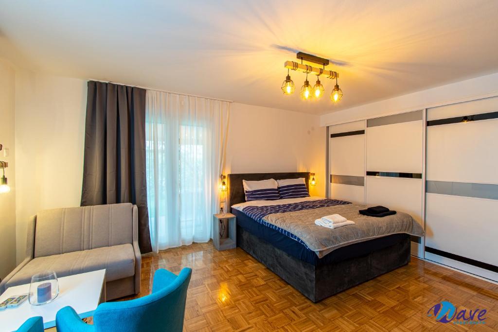 1 dormitorio con 1 cama y 1 silla en MODERN apartments WAVE near the AIRPORT en Velika Gorica