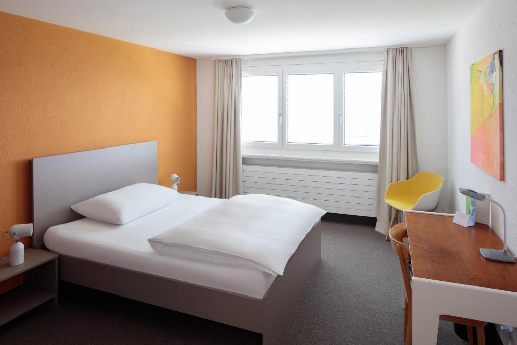 Postel nebo postele na pokoji v ubytování Le Domaine (Swiss Lodge)