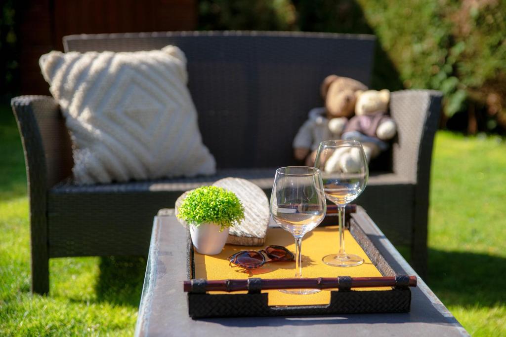 stół z dwoma kieliszkami wina na krześle w obiekcie My Sweet Garden - by MyHomeInComo w mieście Cassina Rizzardi