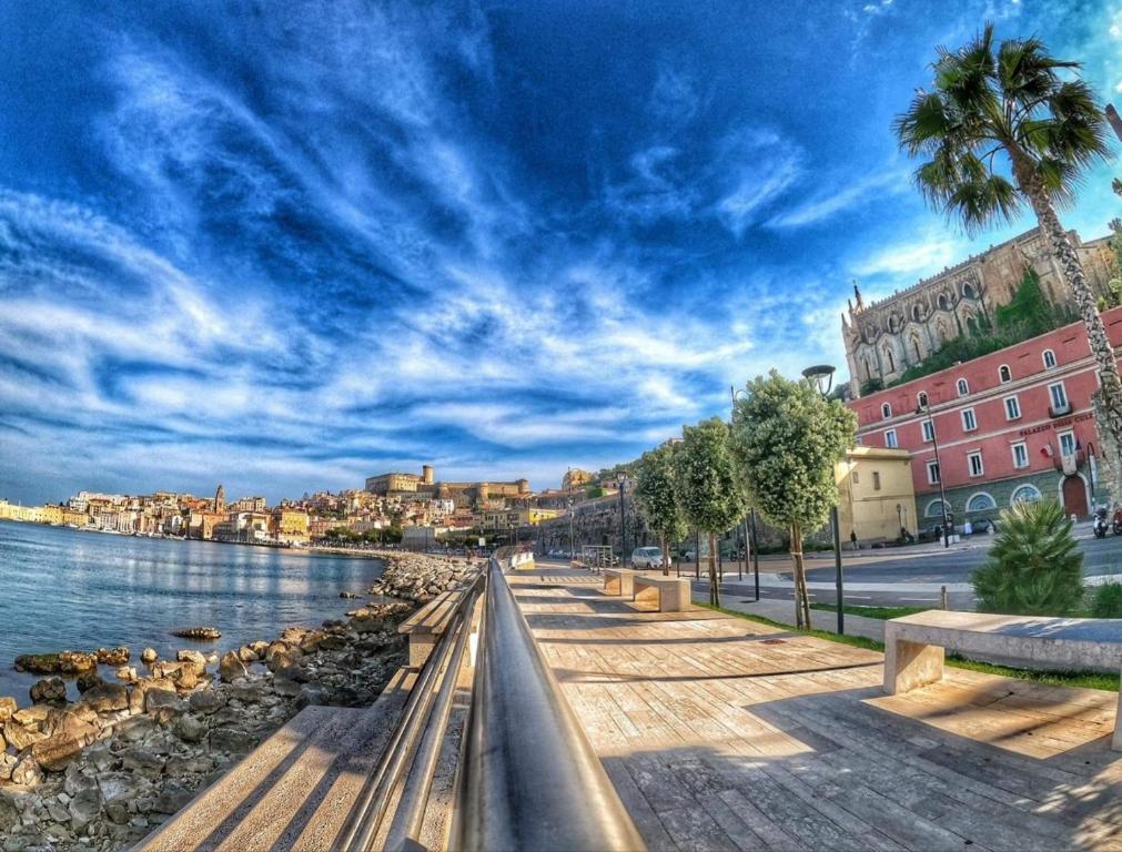 a view of a river with buildings and a palm tree at Brezza di mare Gaeta b&b in Gaeta