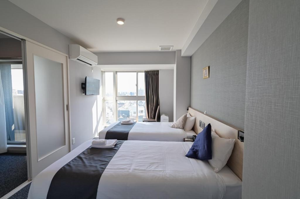 Postel nebo postele na pokoji v ubytování HOTEL STATE TENNOJI