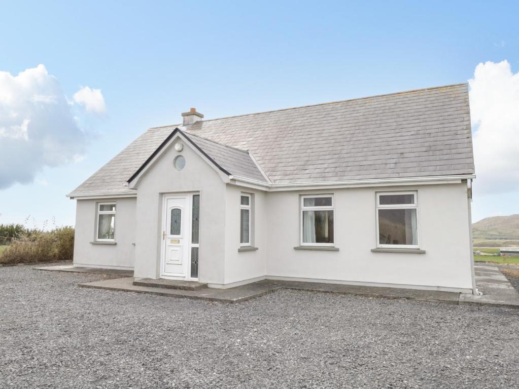 a white house with a gravel driveway at Achill View in Achill