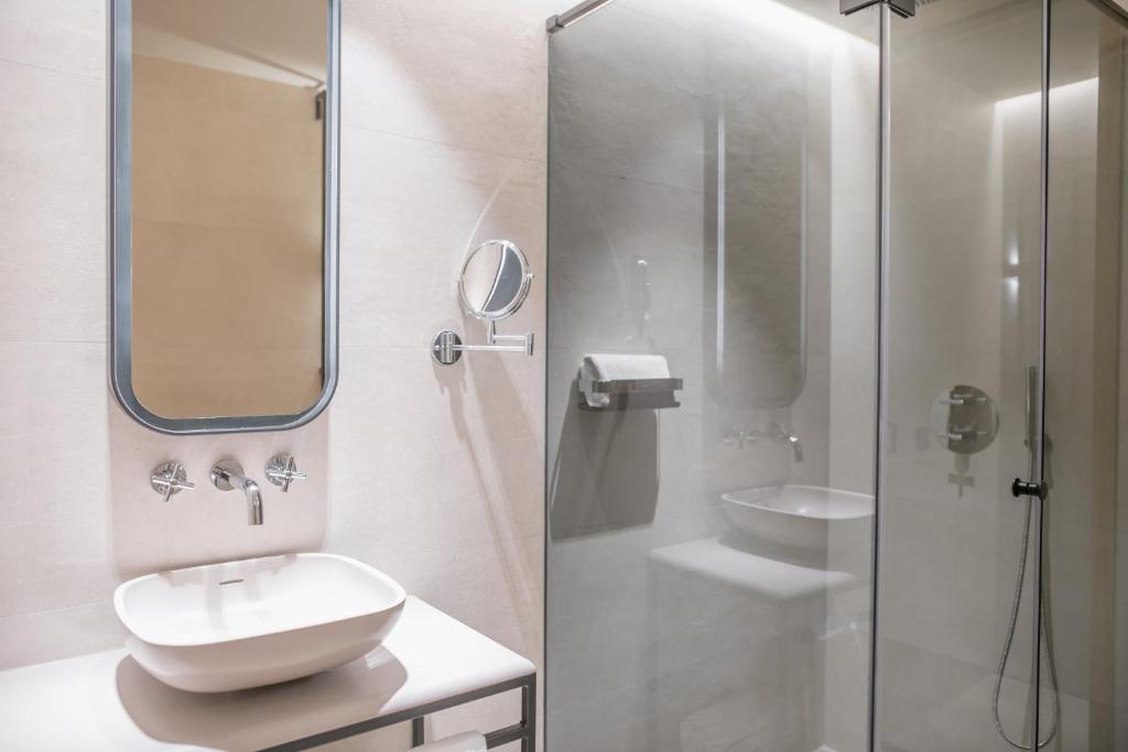 a white bathroom with a sink and a shower at MYR Puerta Serranos in Valencia