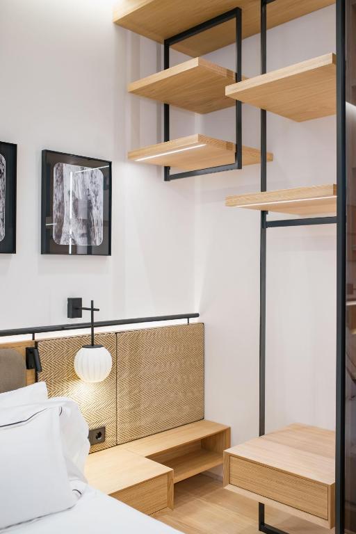 a bedroom with wooden shelves and a bed at MYR Puerta Serranos in Valencia