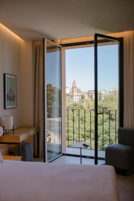 a hotel room with a view of a balcony at MYR Puerta Serranos in Valencia