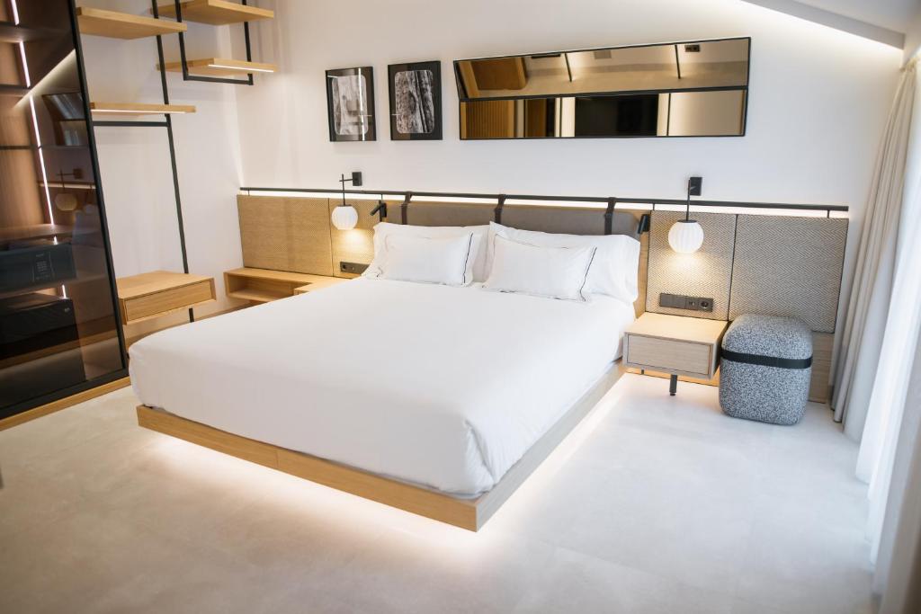 a bedroom with a large white bed in a room at MYR Puerta Serranos in Valencia