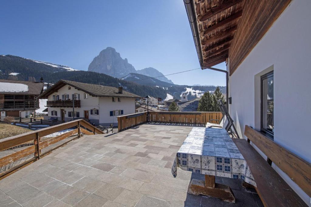 a large patio with a view of a mountain at Apartments Praruf in Selva di Val Gardena