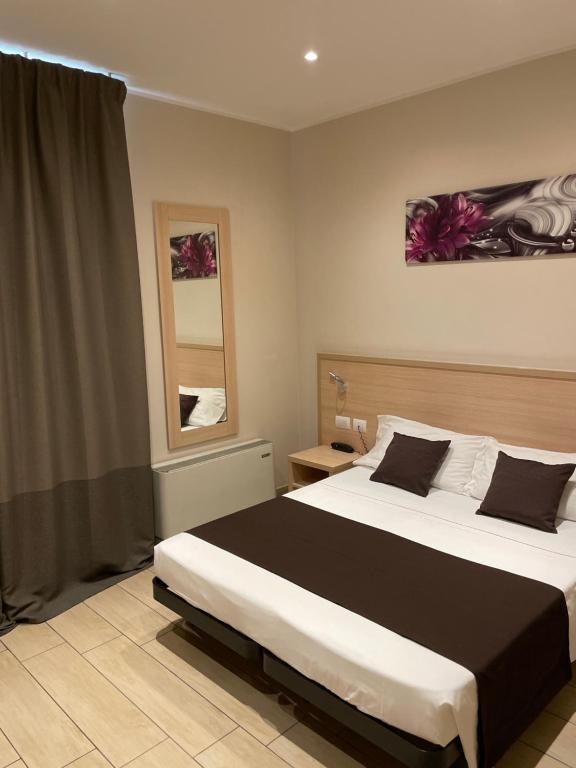 
a hotel room with a bed and a lamp at Hotel San Biagio in Milan
