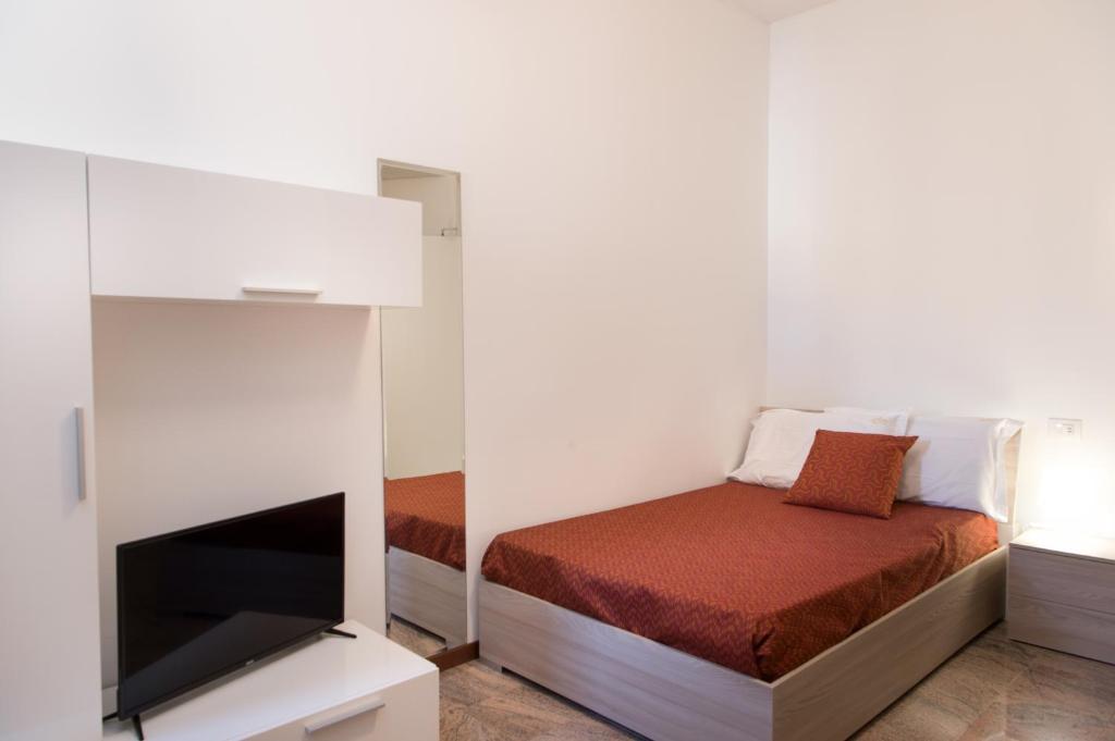 A bed or beds in a room at Ego' Residence Ferrara