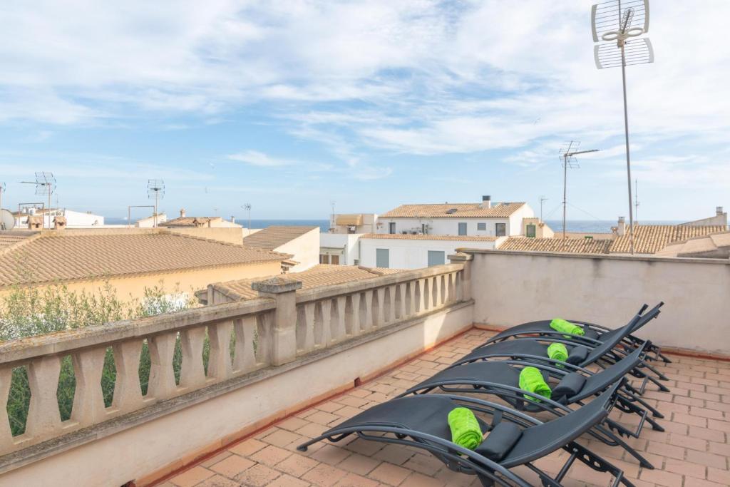Eine Stuhlreihe auf einem Balkon mit dem Meer im Hintergrund in der Unterkunft Habitatge Escorball in Sa Ràpita