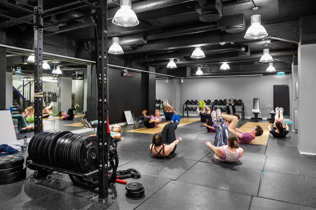 a group of people doing yoga in a gym at Comfort Hotel Børsparken in Oslo