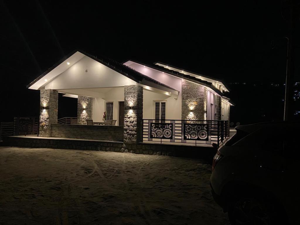 a small house with lights on it at night at RR Holidays - Home Stay in Kodaikānāl