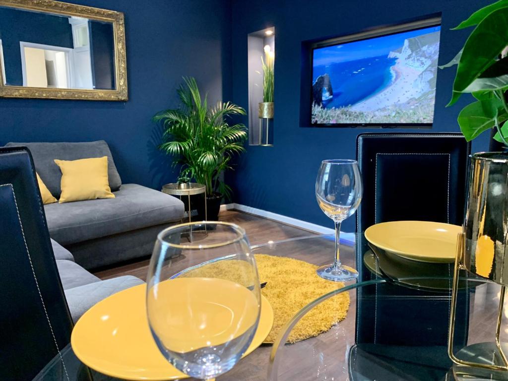a living room with a table and two wine glasses at Cozy Two Bedroom - A Stroll from Gardens to Beach - With Parking in Bournemouth