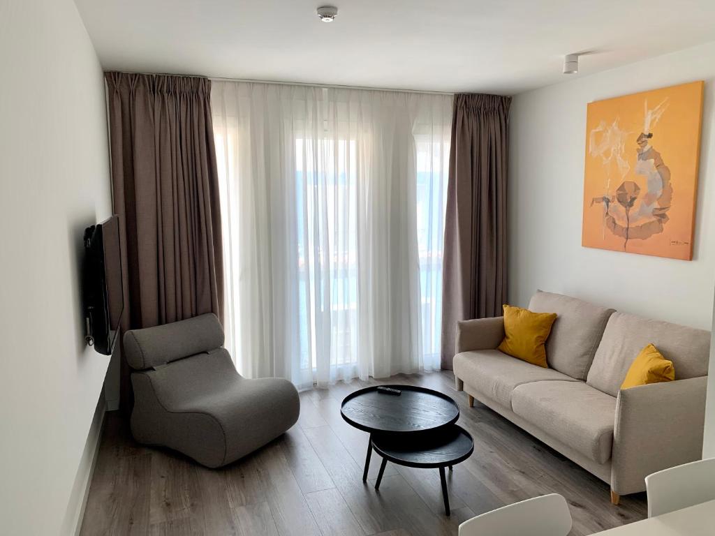 a living room with a couch and a chair and a table at BN SUITES Teatro in Alicante