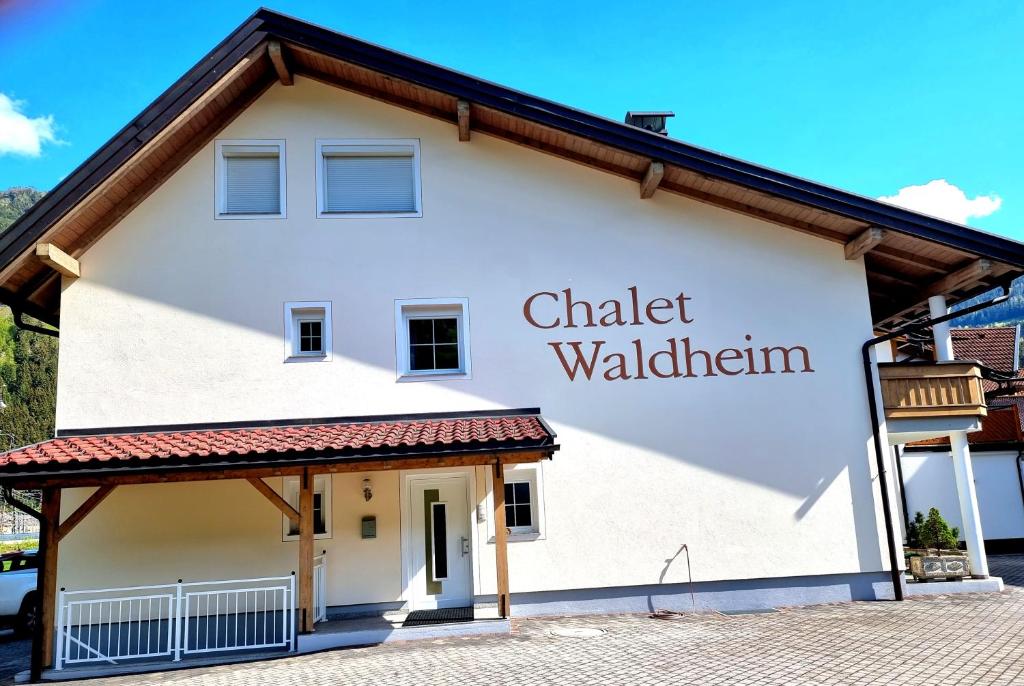 a white building with a sign that reads chater wallundigham at Chalet Waldheim in Zell am Ziller