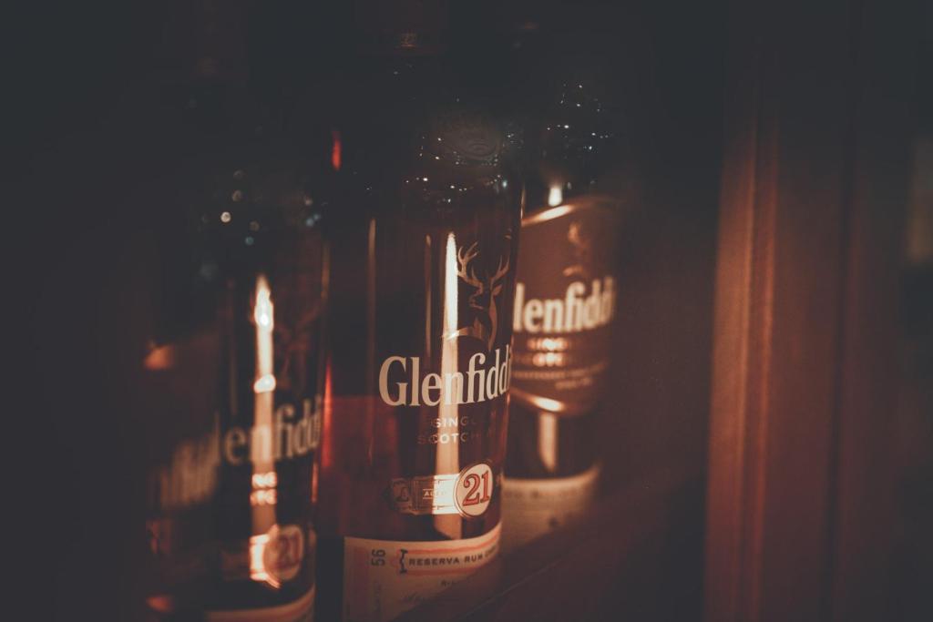 a row of beer bottles sitting on a shelf at Chrielka Hotel in Limassol