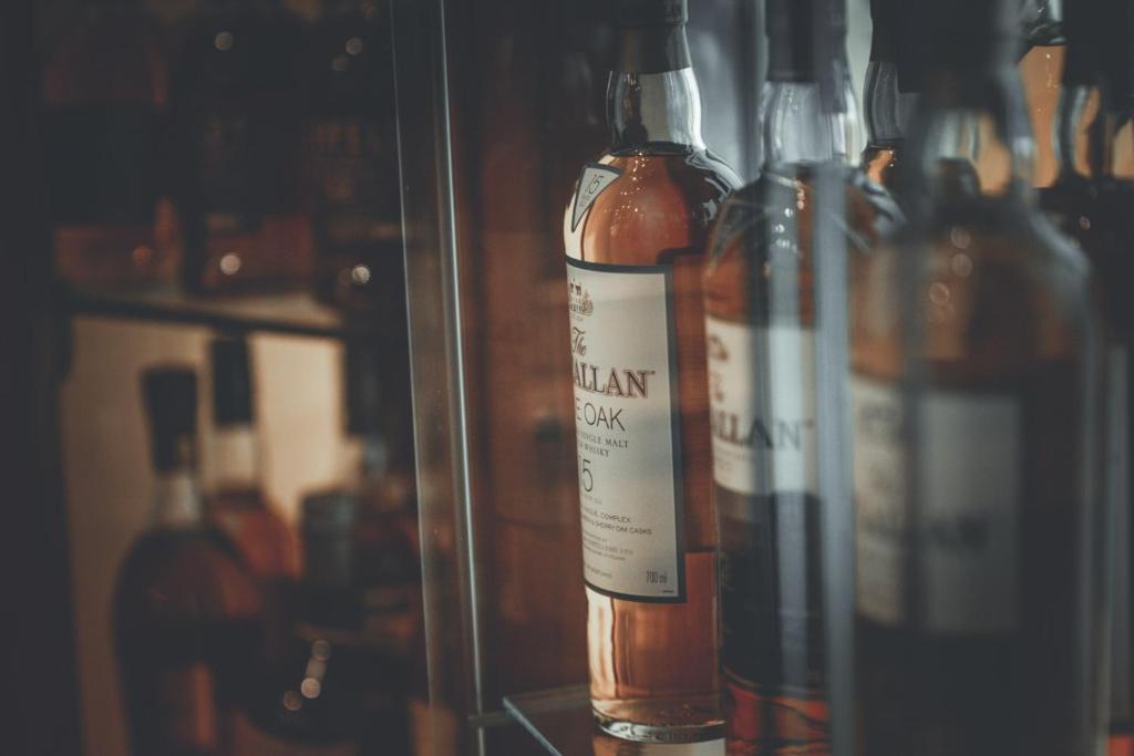 a group of bottles of wine on a shelf at Chrielka Hotel in Limassol