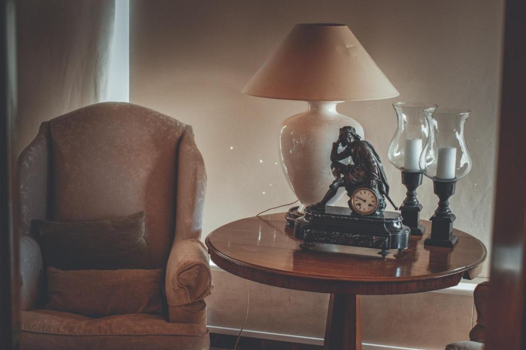 a lamp sitting on a table next to a chair at Chrielka Hotel in Limassol