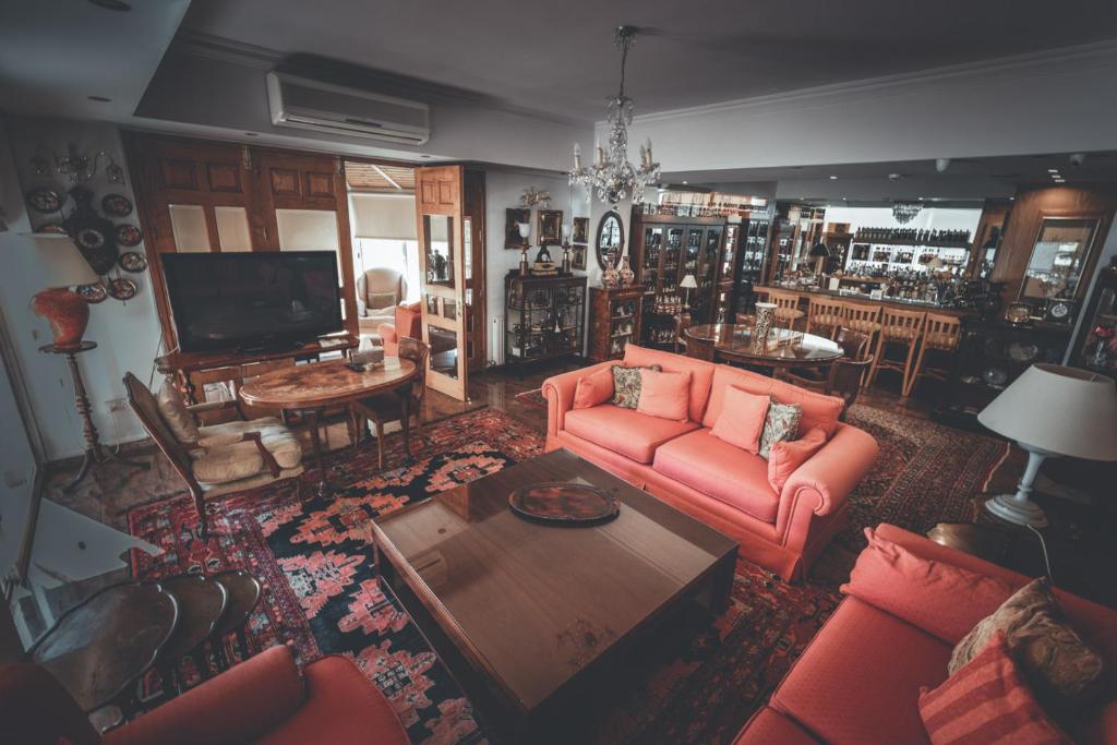 a living room with a couch and a table at Chrielka Hotel in Limassol
