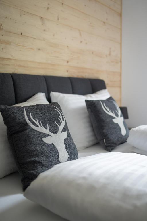 a couch with two pillows with trees on it at Luxalps- Turrach Alm Chalets Nr 1-4 Grünsee- Sauna- Skifahren- Wandern- Natur in Turracher Hohe