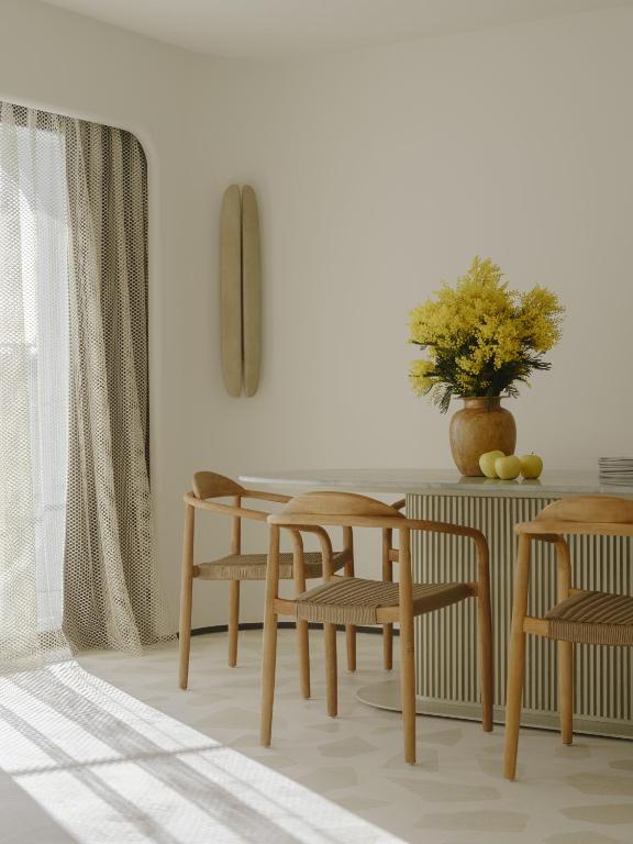 a dining room with a table and chairs at Hôtel & Spa Belle Plage in Cannes