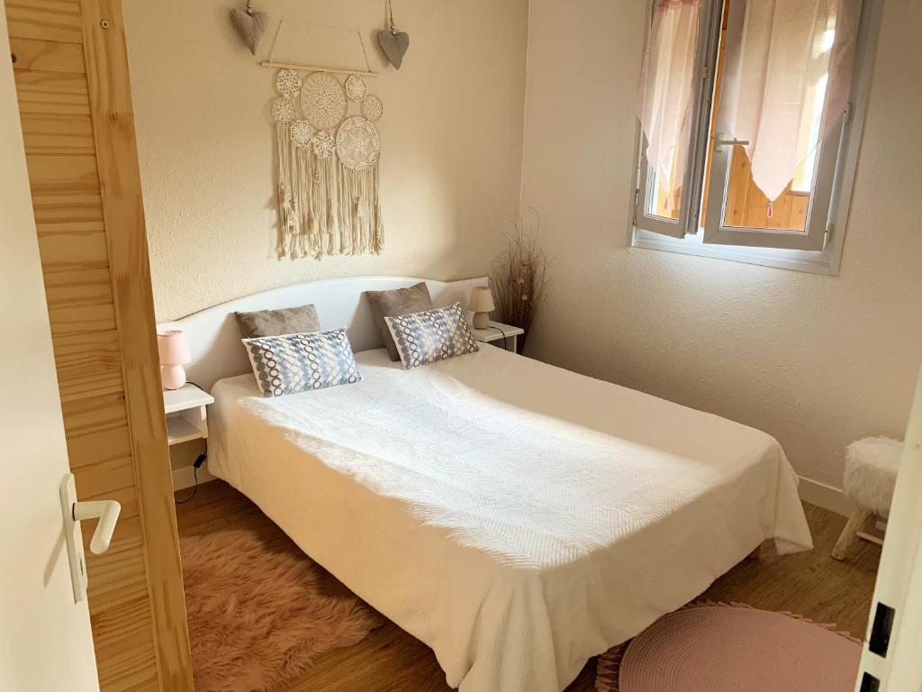sypialnia z białym łóżkiem z 2 poduszkami w obiekcie Appartement de 2 chambres avec balcon et wifi a Bagneres de Bigorre w mieście Bagnères-de-Bigorre