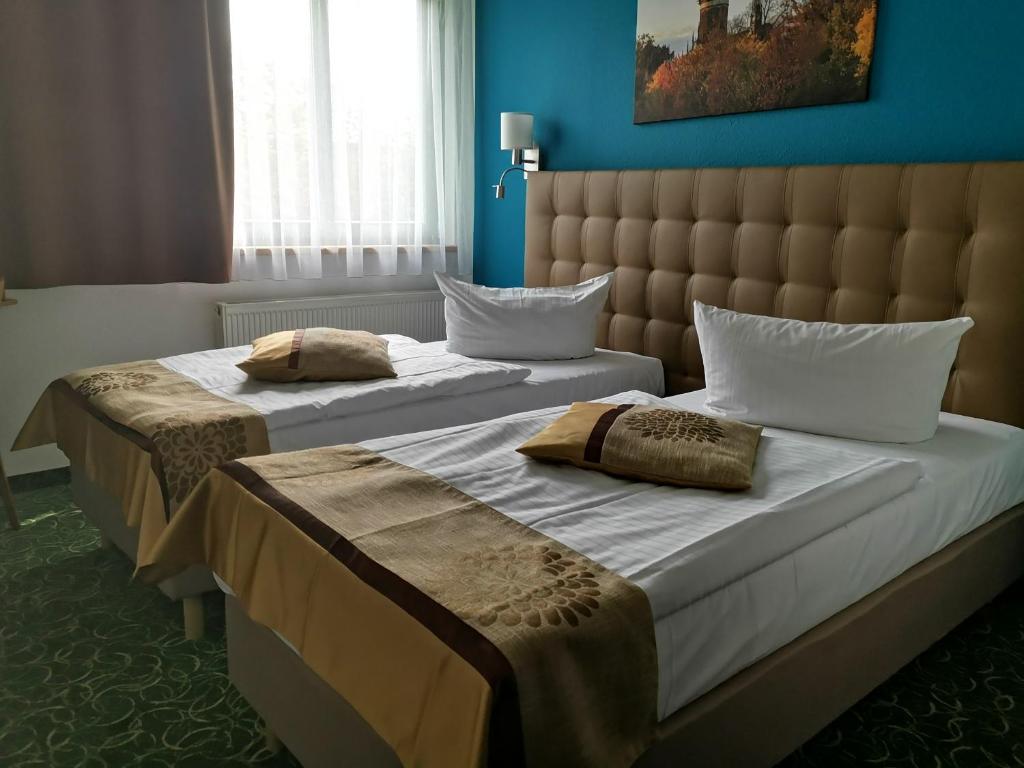 Postel nebo postele na pokoji v ubytování ACRON Hotel Wittenberg
