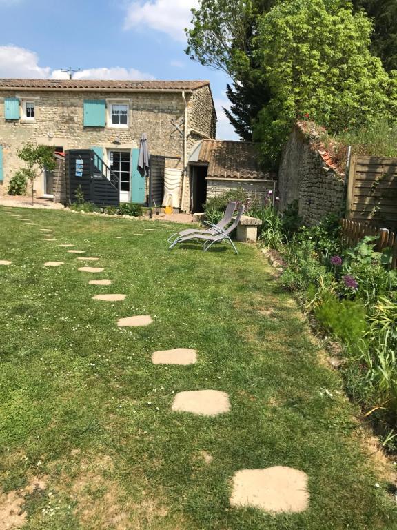 a garden with stepping stones in the grass at L Abricotier in Saint-Crépin