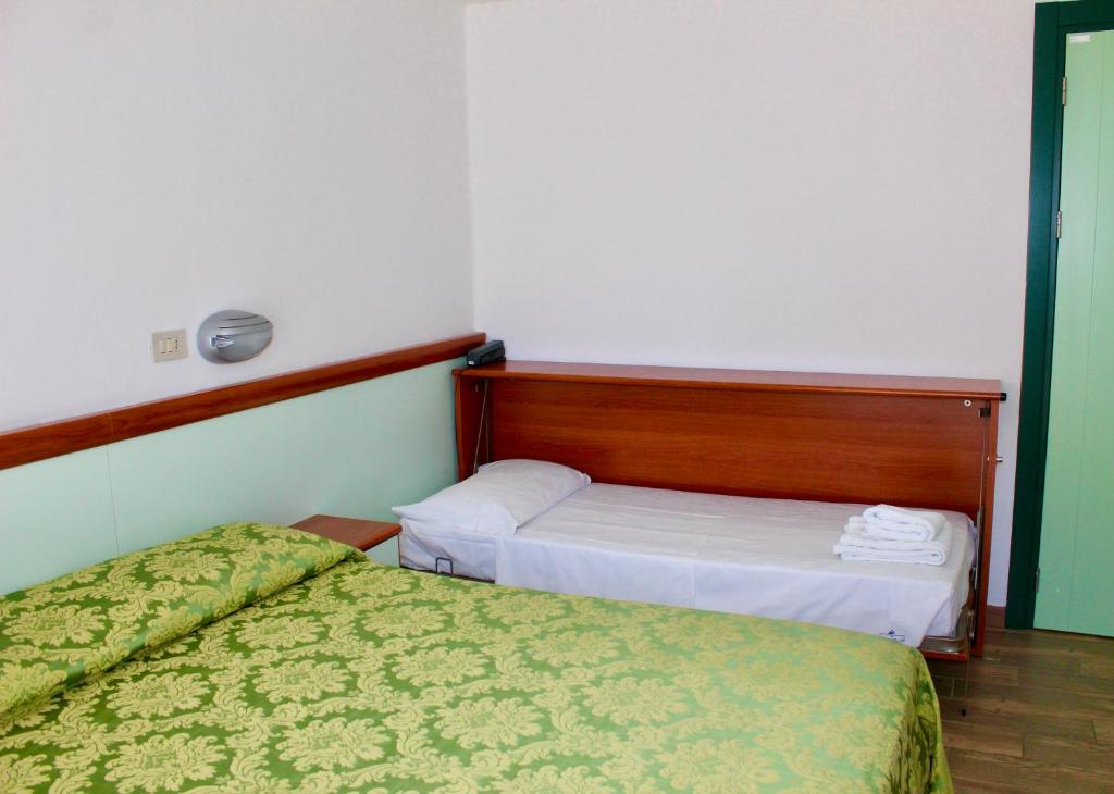 Łóżko lub łóżka w pokoju w obiekcie Hotel Cristina