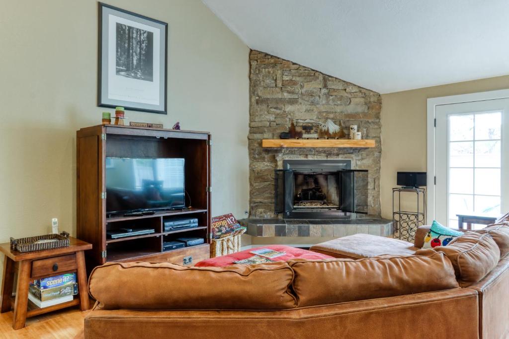 a living room with a couch and a fireplace at Rainier Rest Stop in Sunriver