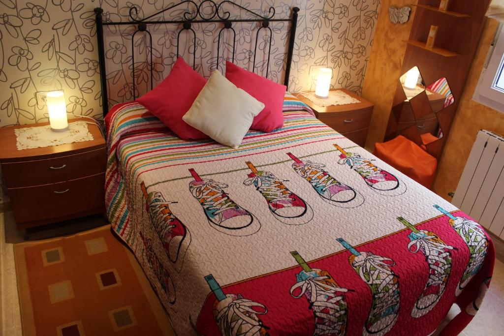 a bedroom with a bed with shoes on it at Piso amplio con vistas al mar y playa a 50 mts in Fisterra