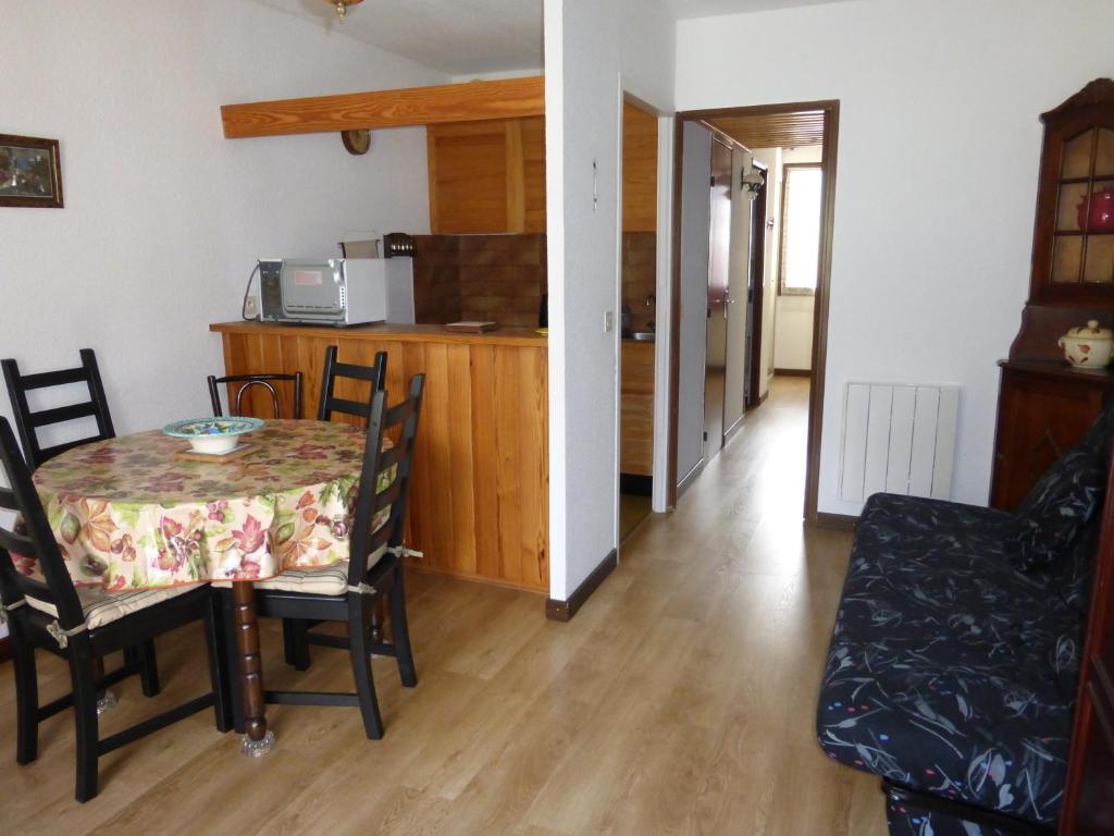 a kitchen and dining room with a table and chairs at Jausiers village A 5 in Jausiers