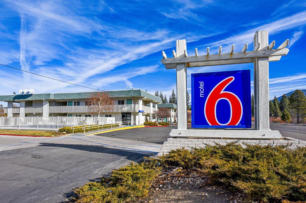 a blue and red sign in front of a building at Motel 6-South Lake Tahoe, CA in South Lake Tahoe