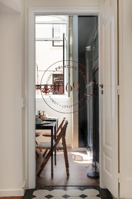 a dining room with a table and a window at 1869 Príncipe Real House in Lisbon