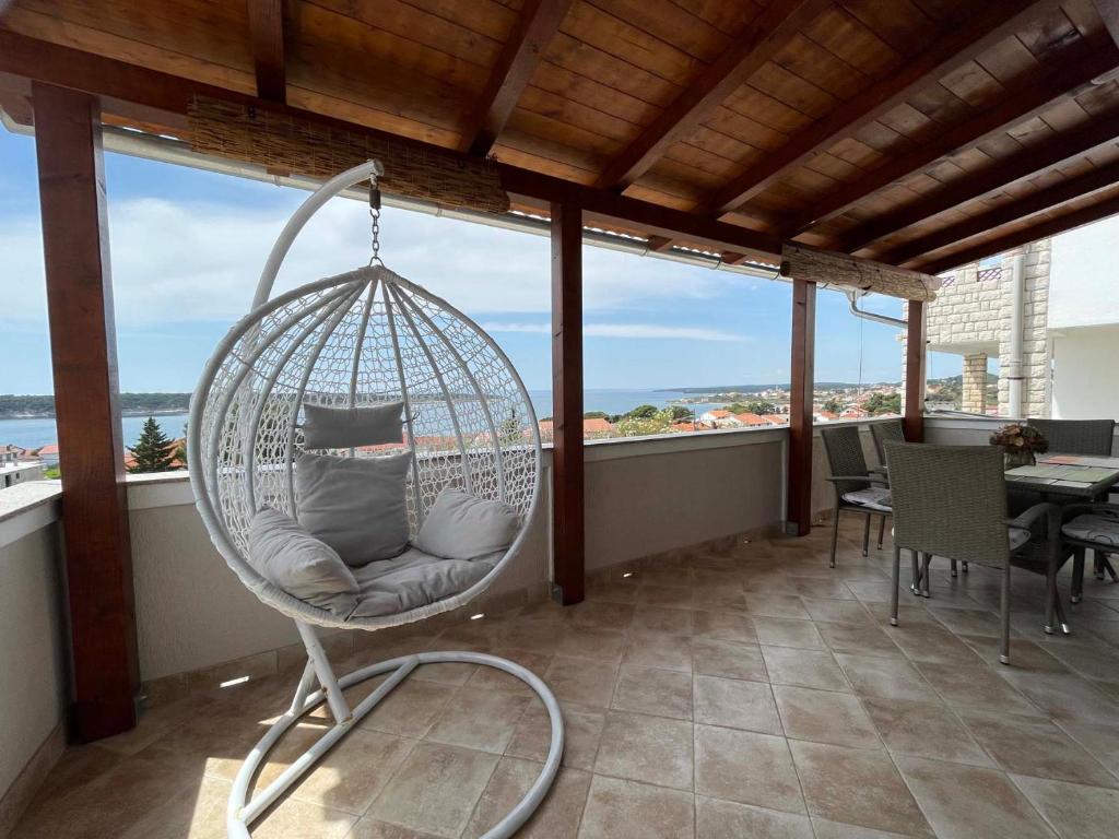 a swinging chair on the balcony of a condo at House Stojakovic in Banjol