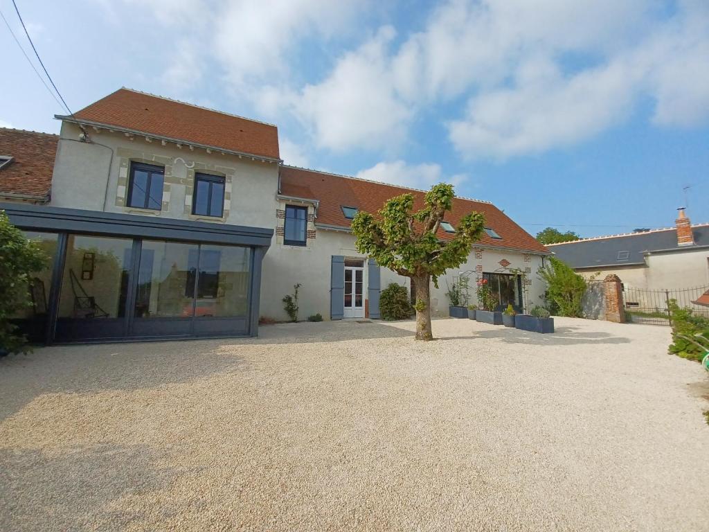 翁赞Rêve de Loire chambres d'hôtes au calme au pied des châteaux de la Loire的车道中间有树的房子