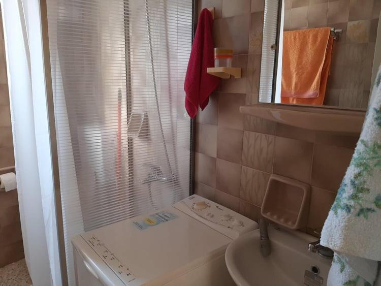 łazienka z umywalką, toaletą i lustrem w obiekcie Μαγευτικο ηλιβασιλεμα Μαρμαρι Ευβοιας w mieście Marmari