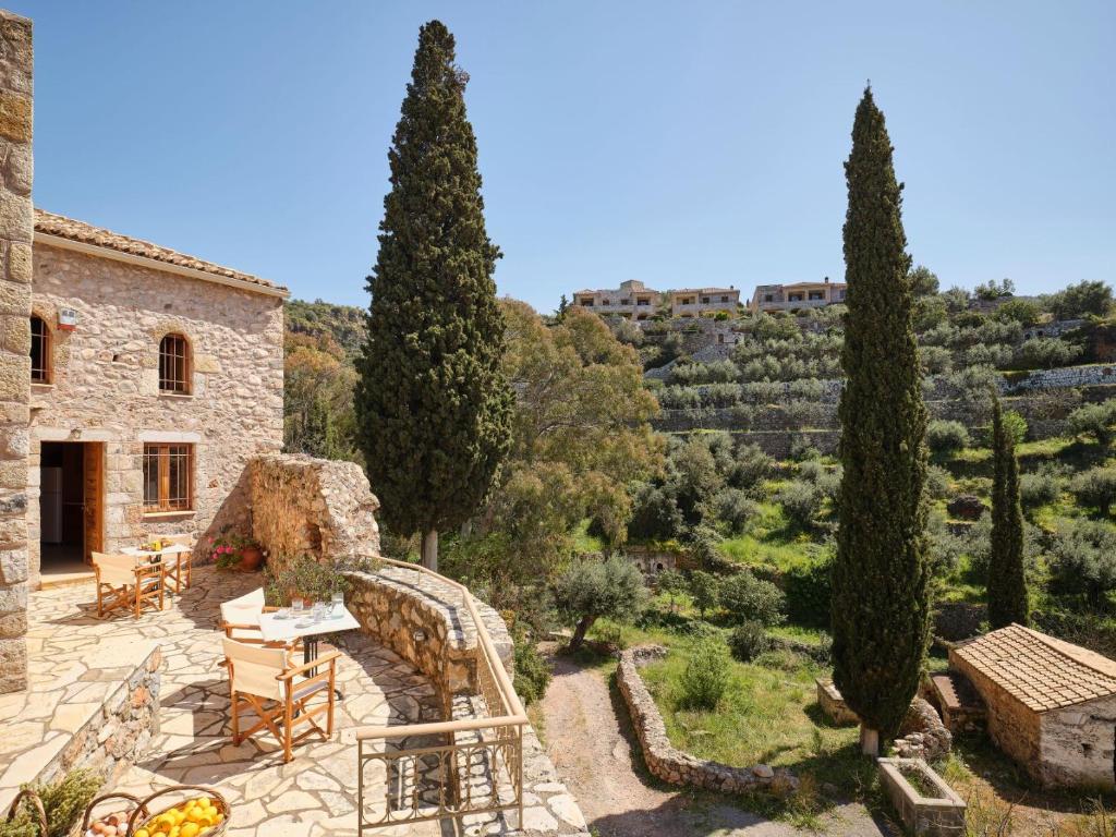 a villa with a view of a garden and trees at Petreas Castle in Kardamili