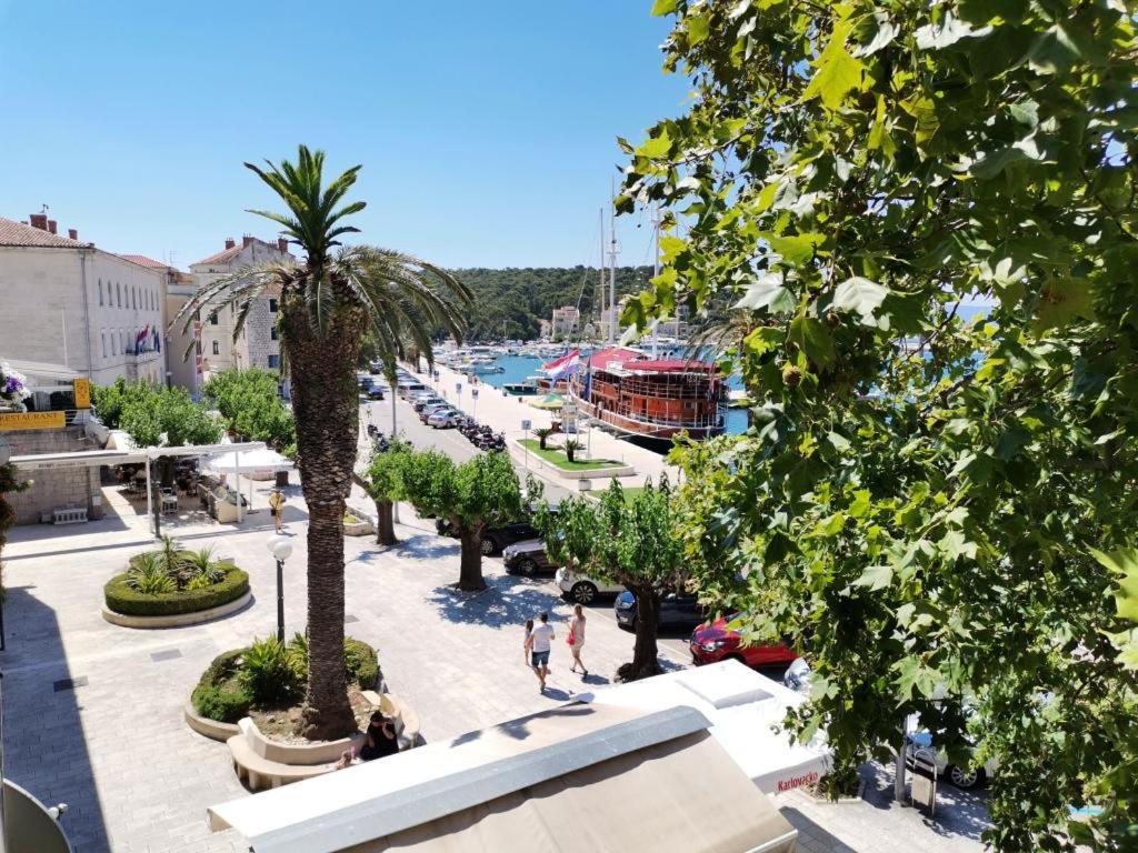 a view of a marina with palm trees at Apartment Riva in Makarska