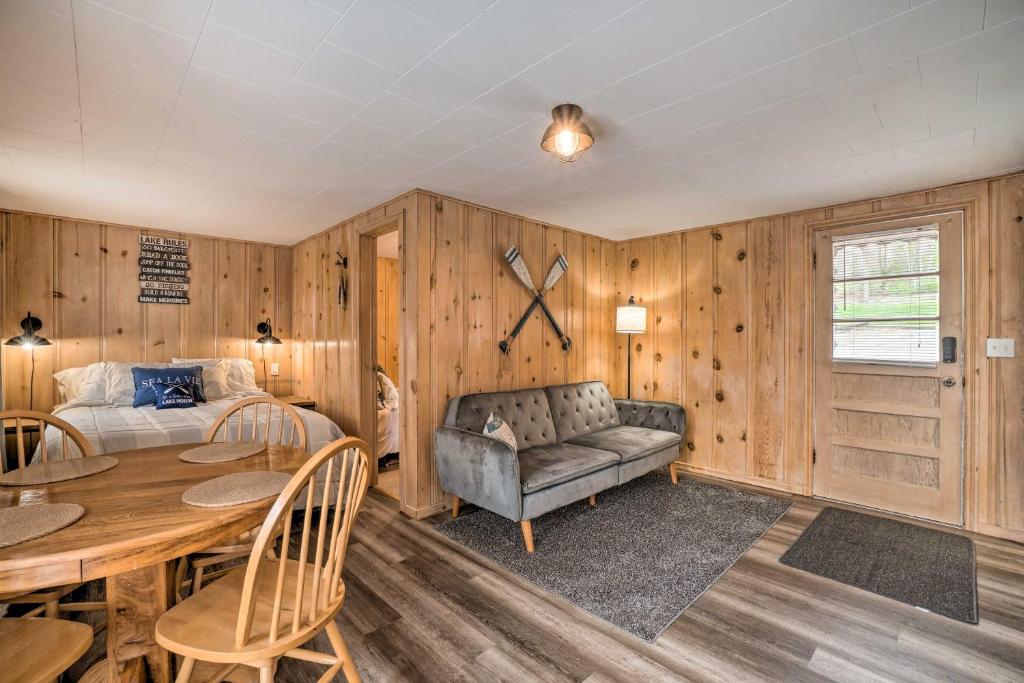 a bedroom with a bed and a table and a couch at Quaint Table Rock Lake Hideout with Pool Access in Reeds Spring