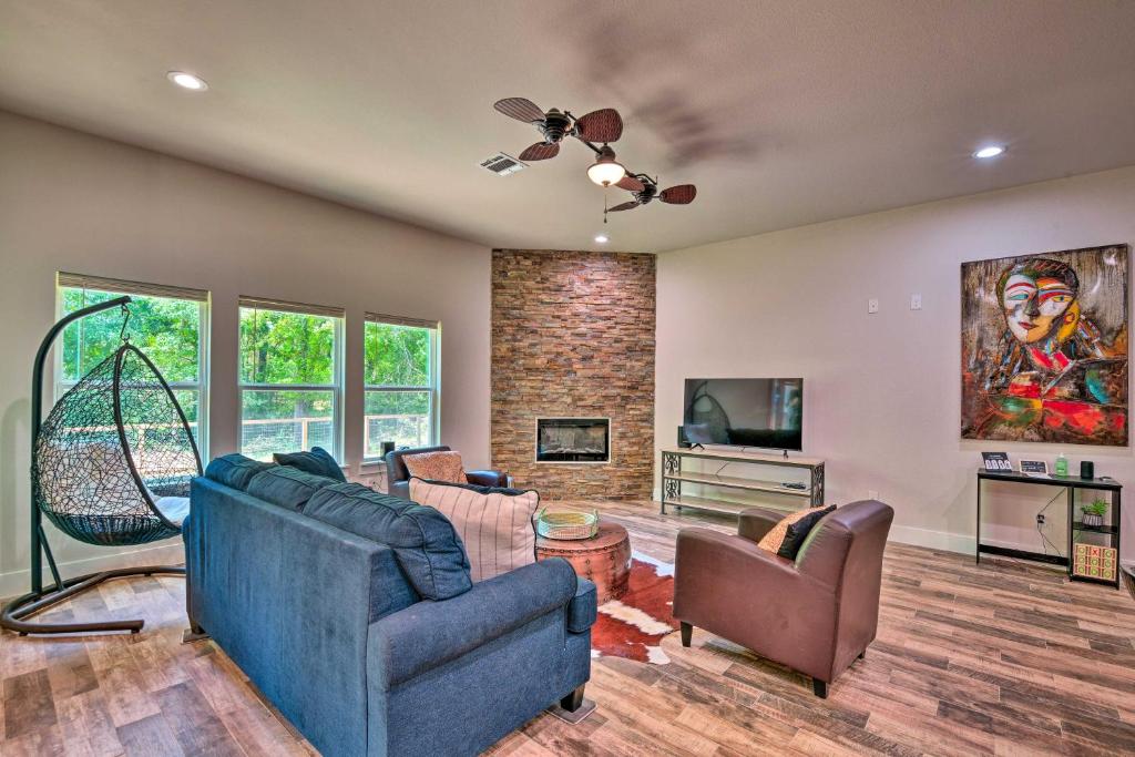 a living room with a couch and a tv at Newly Constructed Mansfield Home with Fenced Yard! in Mansfield