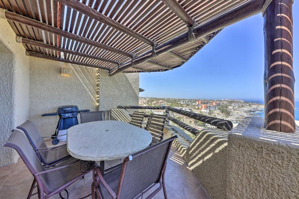 a table and chairs on a balcony with a view at Resort-Style Cabo Getaway with Pools & Ocean Views in Cabo San Lucas