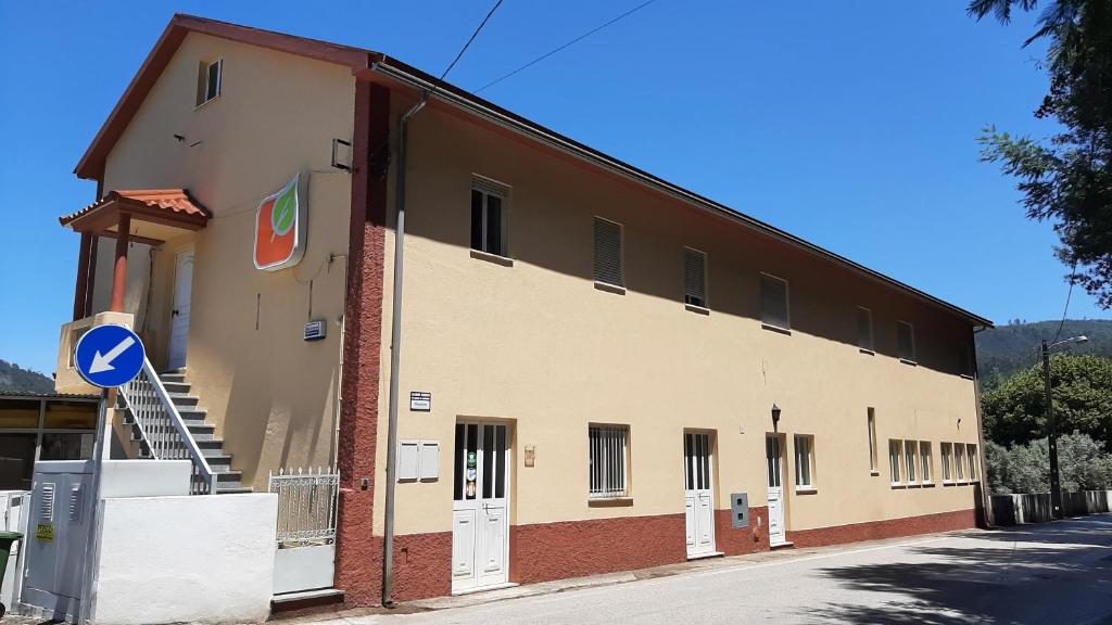 a large building on the side of a street at Hospedaria Lampião in Penacova