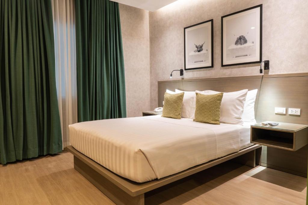 Postel nebo postele na pokoji v ubytování Primeway Suites Cebu