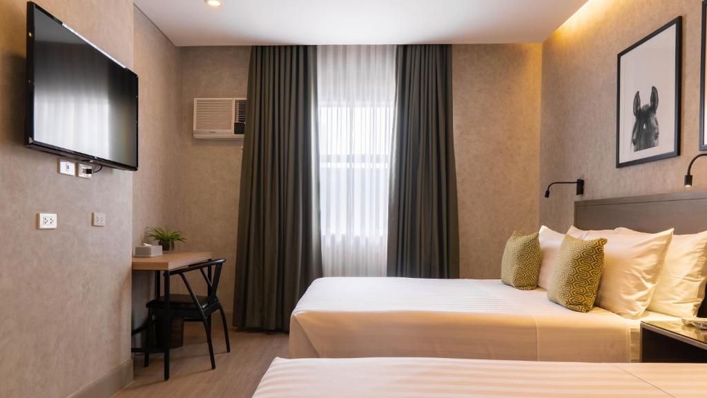 Postel nebo postele na pokoji v ubytování Primeway Suites Cebu