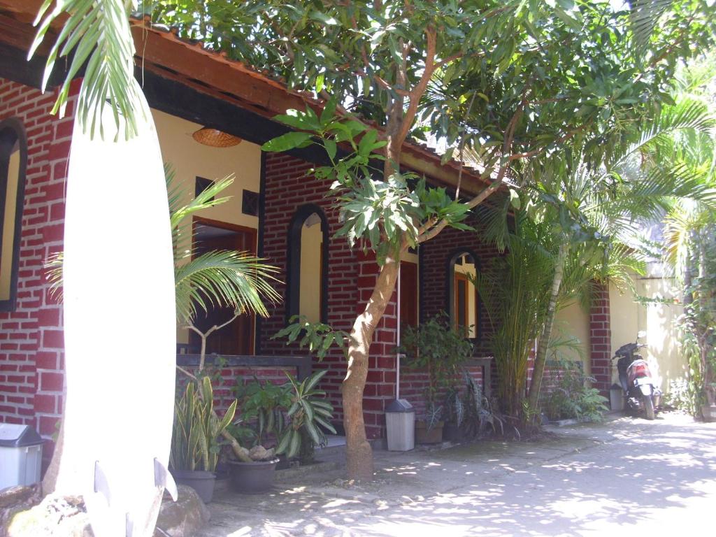 a brick house with trees in front of it at Rinjani Homestay in Pangandaran